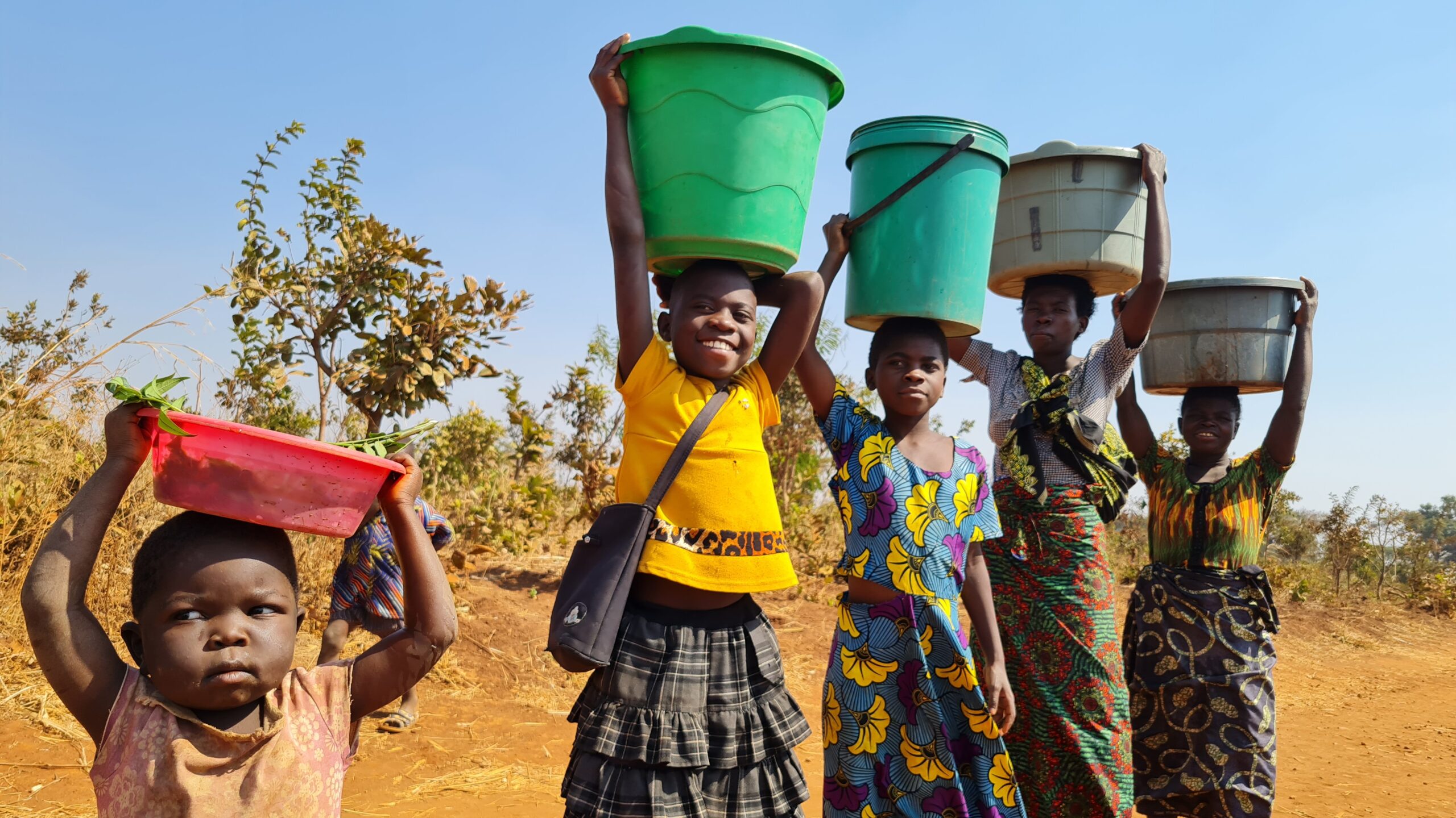 Young girls holding water buckets